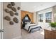 Modern bedroom showcasing an accent wall, unique decor, and natural light at 1465 Auburn Glen Rd, Dacula, GA 30019