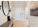 Inviting foyer featuring a bench, decorative mirror, and hardwood floors that lead into the home's living space at 1465 Auburn Glen Rd, Dacula, GA 30019
