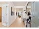 Open and airy entryway with a bench, mirror, and view into the living room and backyard through glass doors at 1465 Auburn Glen Rd, Dacula, GA 30019