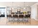 A modern kitchen with gray cabinets, stainless steel appliances, a mosaic backsplash, and an island with bar stool seating at 1465 Auburn Glen Rd, Dacula, GA 30019