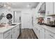 Modern kitchen with white cabinets, stainless steel appliances, and a stylish backsplash at 1465 Auburn Glen Rd, Dacula, GA 30019