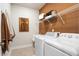 Well-equipped laundry room featuring a white washer and dryer and ample shelving at 1465 Auburn Glen Rd, Dacula, GA 30019
