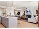 An open-concept living space with a kitchen island and a living room with a fireplace and TV at 1465 Auburn Glen Rd, Dacula, GA 30019