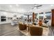 Open-concept living room with neutral furniture, hardwood floors, and ample natural light at 1465 Auburn Glen Rd, Dacula, GA 30019