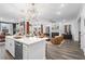 Spacious living room with fireplace, plush seating, and an open view of the modern kitchen at 1465 Auburn Glen Rd, Dacula, GA 30019
