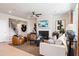 A living room with a fireplace, TV, comfortable seating, and large windows, adjacent to the staircase at 1465 Auburn Glen Rd, Dacula, GA 30019