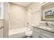 Modern bathroom with a tiled shower, granite vanity, and sleek fixtures at 1643 Pine Glen Cir, Decatur, GA 30035