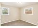 Well-lit bedroom with plush carpeting and two windows offering natural light and views of nature at 1643 Pine Glen Cir, Decatur, GA 30035