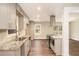 An open kitchen with granite counters, stainless appliances, and a view of the backyard deck at 1643 Pine Glen Cir, Decatur, GA 30035
