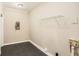 A utility room featuring tile floors, white walls, utility connections, and a wire shelf at 1643 Pine Glen Cir, Decatur, GA 30035