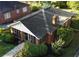 An aerial view featuring a brick home with a sunroom, surrounded by lush landscaping and a well-kept lawn at 2791 Pearl St, East Point, GA 30344