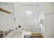 Bright bathroom featuring a sink, toilet, and bathtub with shower; complemented by white walls at 2791 Pearl St, East Point, GA 30344