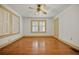 Bright bedroom with hardwood floors, a ceiling fan, and windows with white blinds at 2791 Pearl St, East Point, GA 30344