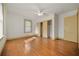 Spacious bedroom with hardwood floors, a ceiling fan, and a large window for natural light at 2791 Pearl St, East Point, GA 30344