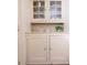 Built-in cabinet with glass doors and painted in a neutral color to complement the walls at 2791 Pearl St, East Point, GA 30344