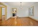 Bright dining room featuring hardwood floors and decorative lighting with a view into the kitchen at 2791 Pearl St, East Point, GA 30344