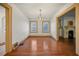 Well-lit dining room featuring hardwood floors, a light fixture, and convenient access to the living room at 2791 Pearl St, East Point, GA 30344