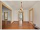 Dining room showcasing hardwood floors, a decorative light fixture, and access to multiple rooms at 2791 Pearl St, East Point, GA 30344