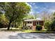 Charming brick home featuring a cozy front porch and mature landscaping at 2791 Pearl St, East Point, GA 30344