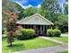 Charming brick home featuring a quaint front porch and lush landscaping at 2791 Pearl St, East Point, GA 30344