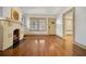 Inviting living room with a decorative fireplace and hardwood flooring and a view to the entry door at 2791 Pearl St, East Point, GA 30344