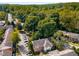 Aerial view of the townhome community featuring lush trees, private parking, and well-maintained buildings at 6700 Roswell Rd # 15B, Atlanta, GA 30328