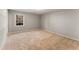 Comfortable carpeted bedroom with a large window and neutral decor at 6700 Roswell Rd # 15B, Atlanta, GA 30328