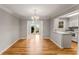 Elegant dining area with hardwood floors, chandelier, and convenient access to kitchen at 6700 Roswell Rd # 15B, Atlanta, GA 30328