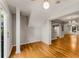 Bright entryway boasts hardwood flooring, neutral walls, and a view of the kitchen and dining area at 6700 Roswell Rd # 15B, Atlanta, GA 30328