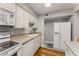 Functional kitchen showcasing white appliances, ample counter space, and convenient access to the entryway at 6700 Roswell Rd # 15B, Atlanta, GA 30328