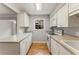 A clean and spacious kitchen featuring white cabinets, modern appliances, and ample countertop space at 6700 Roswell Rd # 15B, Atlanta, GA 30328
