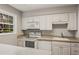 Bright kitchen featuring white appliances, countertops, and cabinets for a clean modern look at 6700 Roswell Rd # 15B, Atlanta, GA 30328