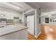 Bright kitchen offering white appliances, counters, and cabinets seamlessly connected to the open living space at 6700 Roswell Rd # 15B, Atlanta, GA 30328