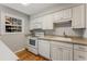 A well-lit kitchen with white cabinets, a window, and modern appliances for efficient meal preparation at 6700 Roswell Rd # 15B, Atlanta, GA 30328