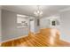 Spacious living area with hardwood floors, light-colored walls, and an open view to the kitchen at 6700 Roswell Rd # 15B, Atlanta, GA 30328