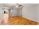 Open-concept living area with hardwood flooring and views to the kitchen and outdoor patio at 6700 Roswell Rd # 15B, Atlanta, GA 30328