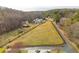 Sprawling acreage featuring a house and barn enclosed by a black fence at 714 Billings Farm Ln, Canton, GA 30115