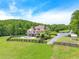Expansive estate featuring a pool, fenced yard, lush greenery, and a charming rear exterior at 714 Billings Farm Ln, Canton, GA 30115
