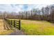 Spacious lot with mature trees and a dark wooden fence at 714 Billings Farm Ln, Canton, GA 30115