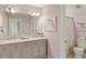 Bright bathroom featuring a double vanity, framed art, and charming floral shower curtain at 714 Billings Farm Ln, Canton, GA 30115