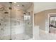 Modern bathroom featuring a glass shower with dual showerheads, marble tiling, and elegant fixtures at 714 Billings Farm Ln, Canton, GA 30115