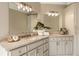 Bright bathroom featuring dual sinks, natural stone countertops and vanity with ample storage at 714 Billings Farm Ln, Canton, GA 30115