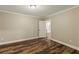 Unfurnished bedroom with wood floors and a doorway leading to another room in the house at 714 Billings Farm Ln, Canton, GA 30115