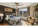 Cozy bedroom with a queen bed, hardwood floors, and a large window offering views of the backyard at 714 Billings Farm Ln, Canton, GA 30115
