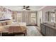 Bright bedroom with a queen bed, hardwood floors, and floral wallpaper creating a relaxing atmosphere at 714 Billings Farm Ln, Canton, GA 30115