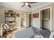 Bedroom featuring a built-in desk, hardwood floors, and a ceiling fan for added comfort at 714 Billings Farm Ln, Canton, GA 30115