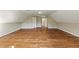 Large bonus room with hardwood floors and neutral colored walls at 714 Billings Farm Ln, Canton, GA 30115