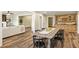 Large dining room with a rustic wood table, modern chairs, and a built-in bar area for entertaining at 714 Billings Farm Ln, Canton, GA 30115