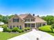 Stunning brick home featuring manicured landscaping, a covered front porch, and a circular driveway with a water fountain at 714 Billings Farm Ln, Canton, GA 30115