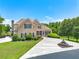Beautiful brick home with a well-manicured lawn, mature trees, and a circular driveway with a water fountain at 714 Billings Farm Ln, Canton, GA 30115